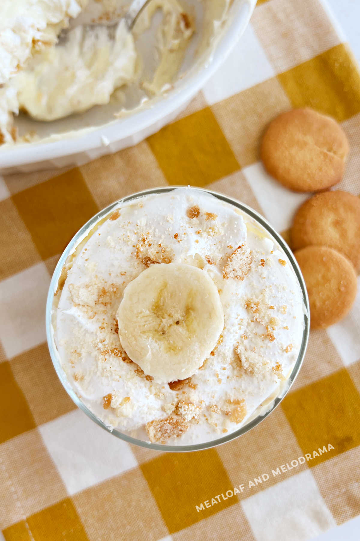 no bake banana pudding with banana slices, cool whip and nilla wafer cookies in glass jar