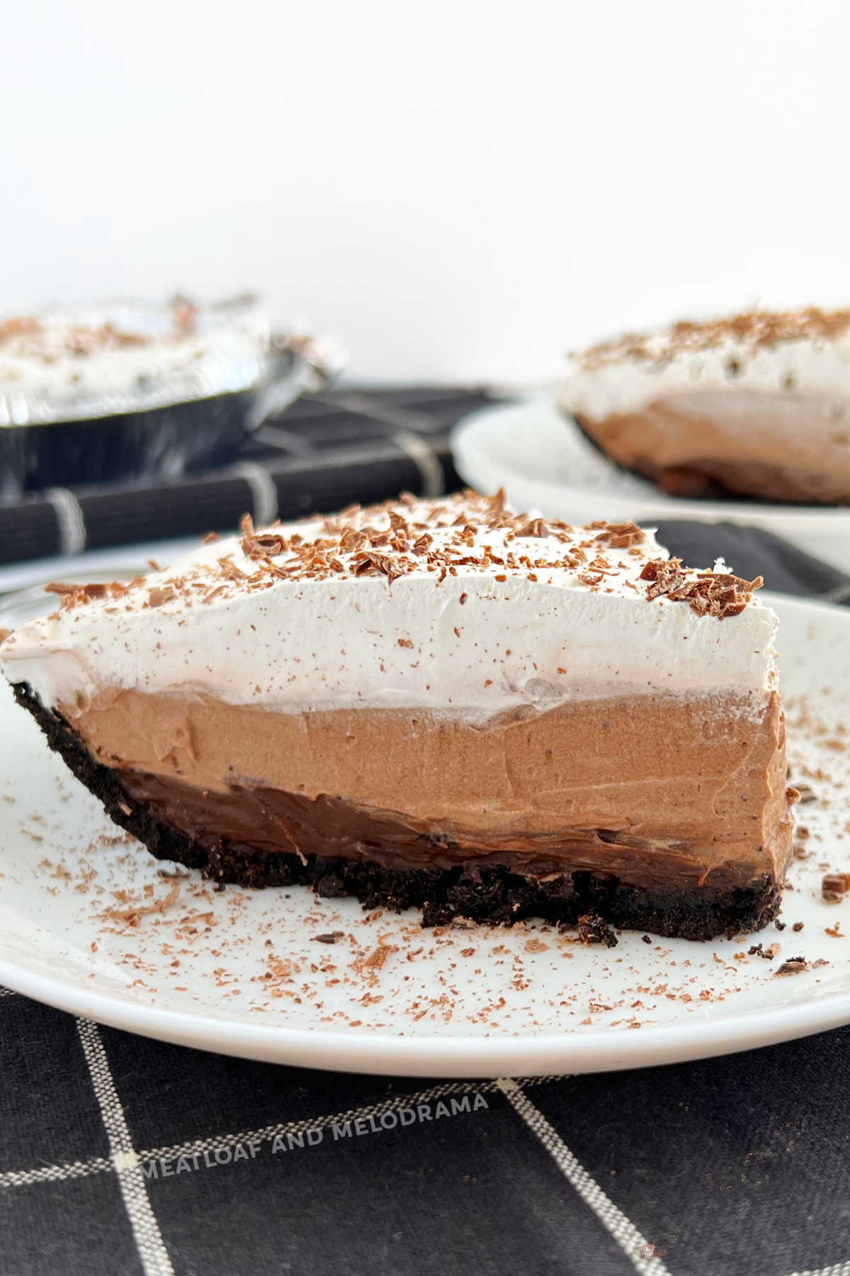 no bake chocolate pudding pie with layered instant jello pudding and cool whip on plate