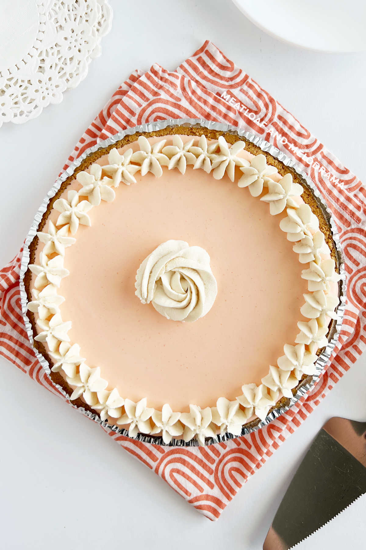 overhead view of no bake creamsicle pie decorated with whipped cream rose and stars