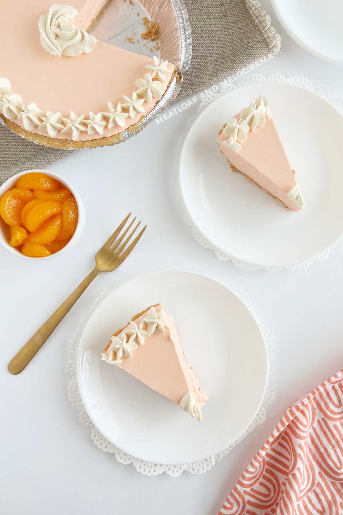 jello creamsicle pie with whipped cream and mandarin oranges on table