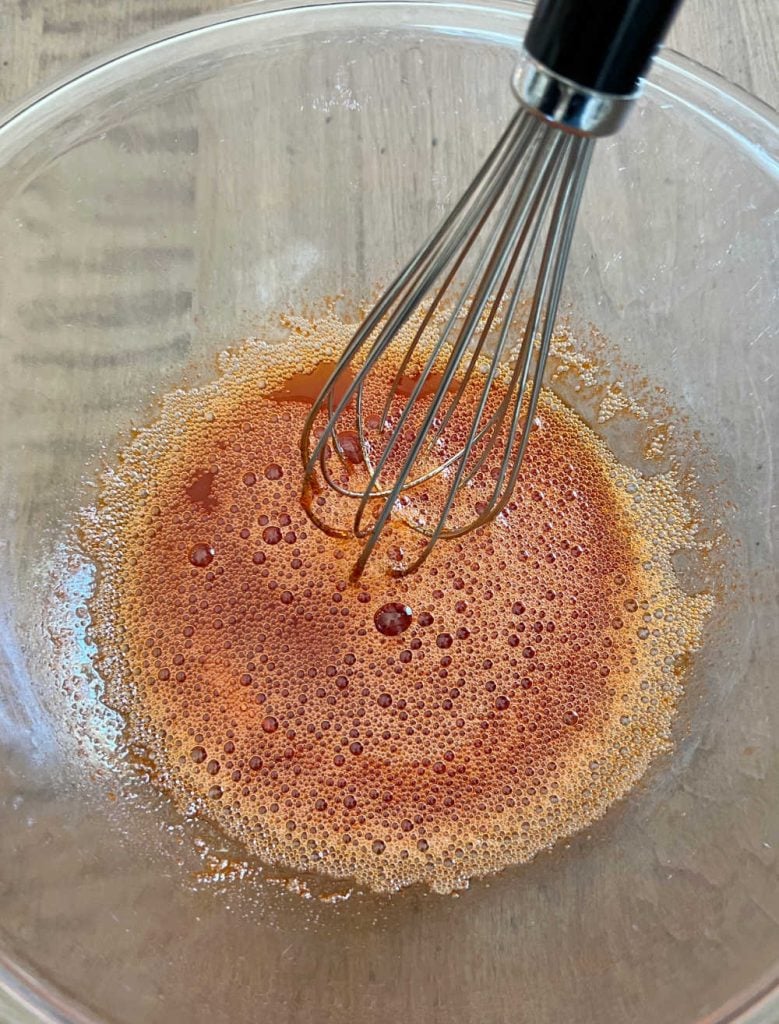 whisk orange jello gelatin and boiling water in mixing bowl