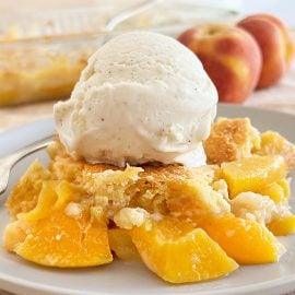 peach dump cake recipe with scoop of vanilla ice cream on top