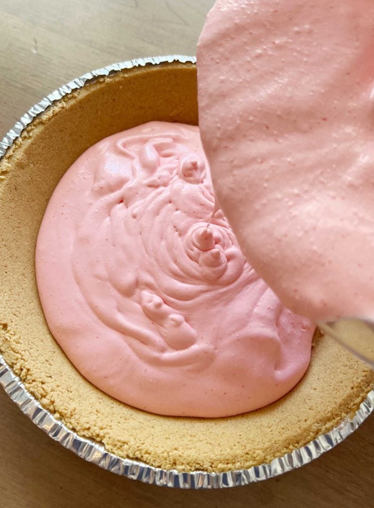 spoon jello cool whip pie filling into pie shell
