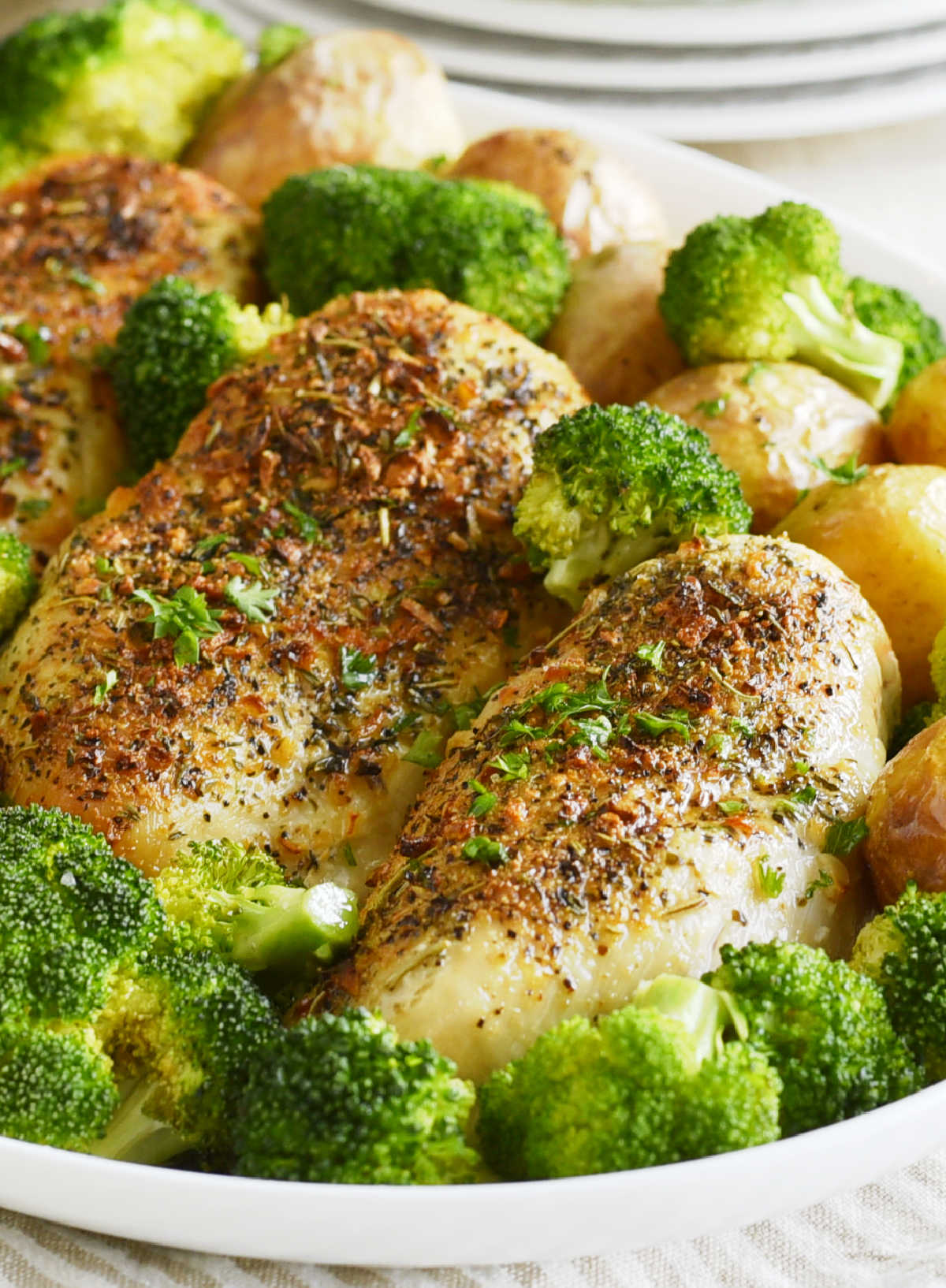 air fryer chicken breasts and potatoes with broccoli on platter