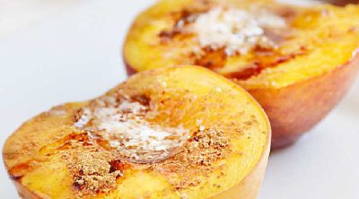 baked peaches with brown sugar and cinnamon on a plate