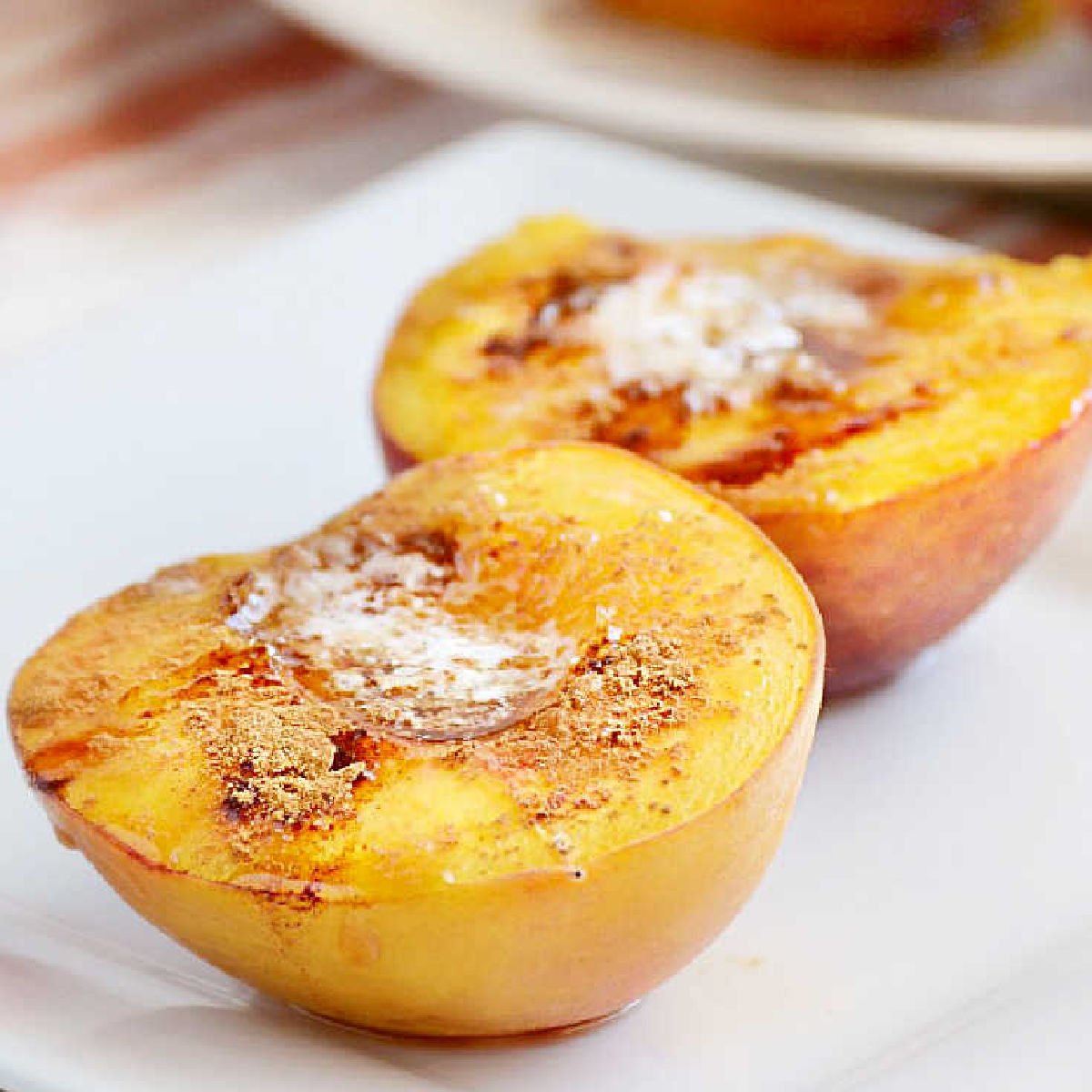 baked peaches with brown sugar and cinnamon on a plate