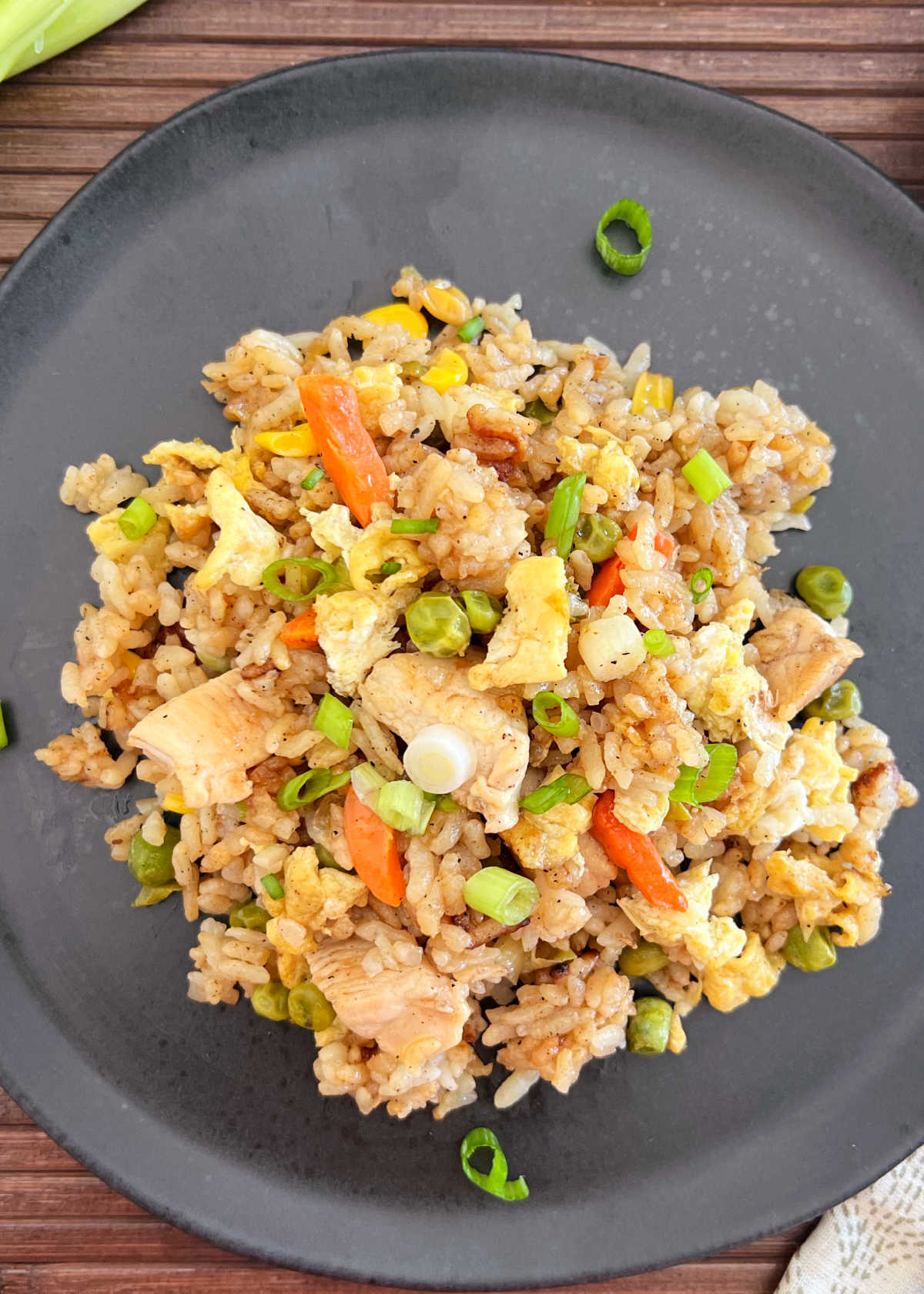 blackstone chicken fried rice with egg and vegetables and green onions on plate