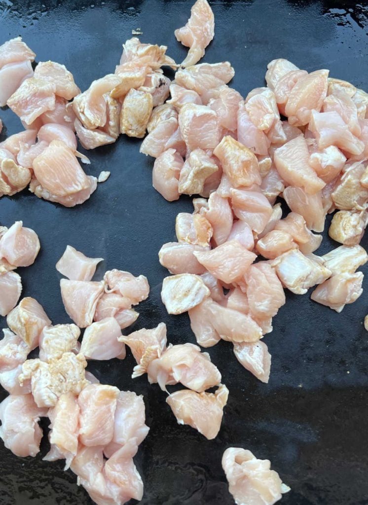 cut up chicken breasts on blackstone griddle