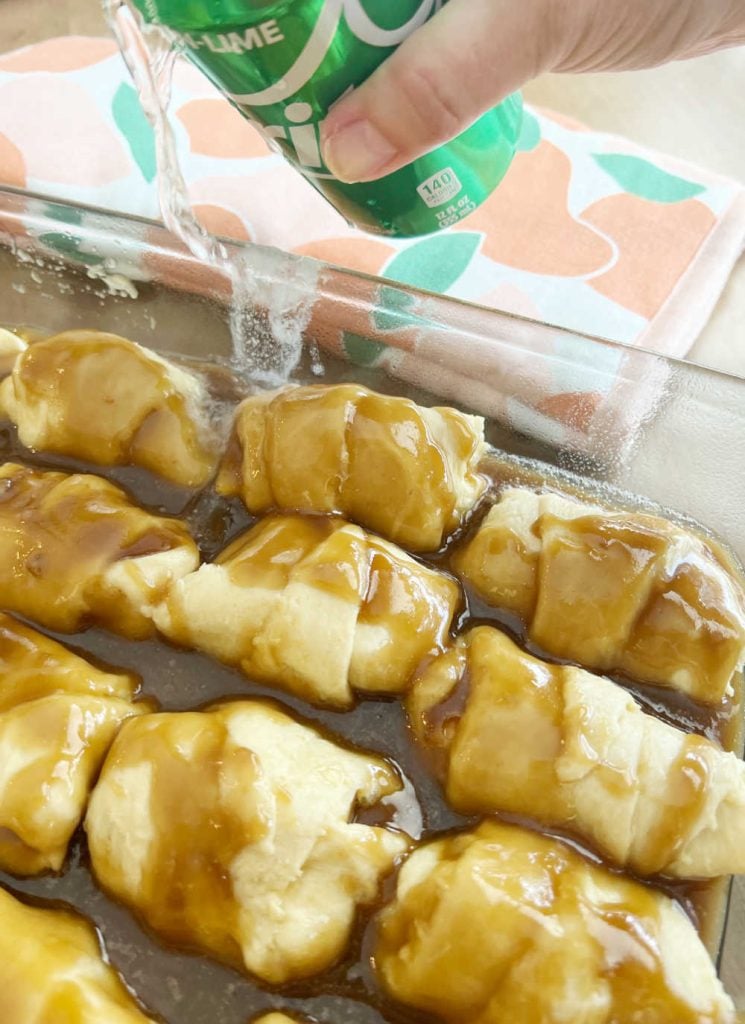 pour can of sprite over peach crescent roll dumplings in pan