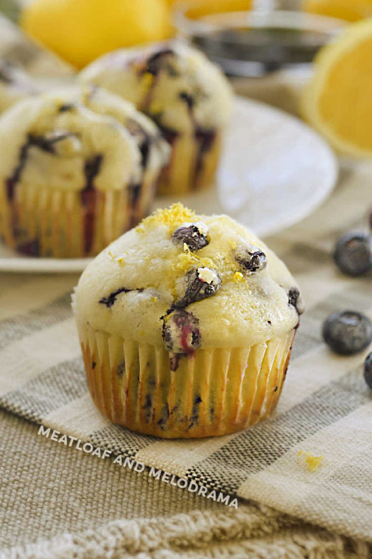 glazed lemon blueberry muffins with fresh blueberries and lemon zest and lemon glaze