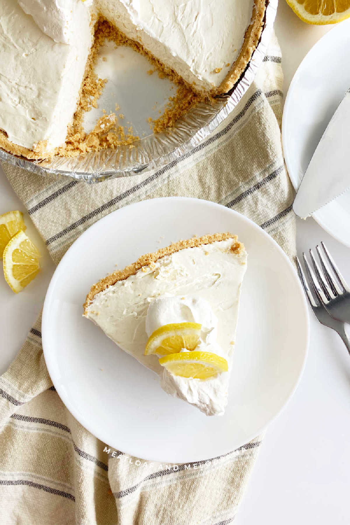 slice of kool aid pie with lemon slices on table