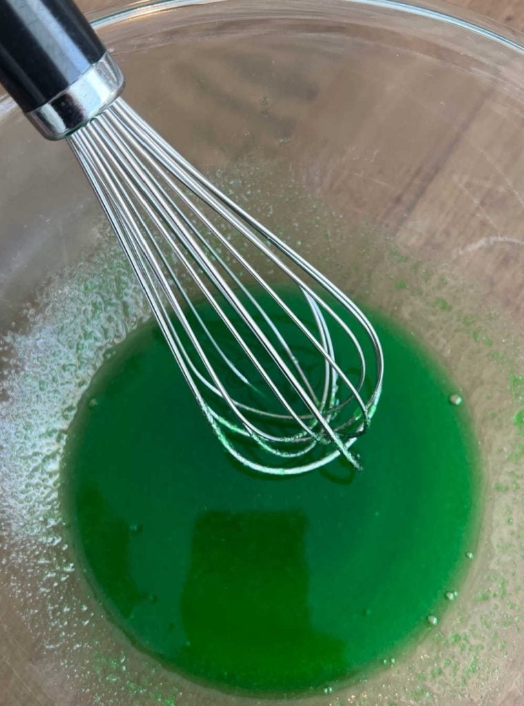 whisk lime jello and hot water in mixing bowl