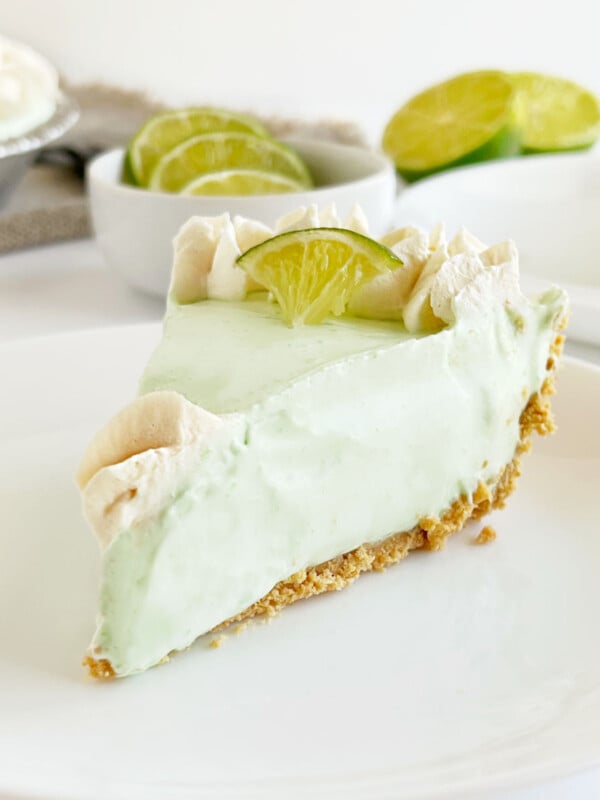 slice of no bake key lime pie with graham cracker crust on a plate