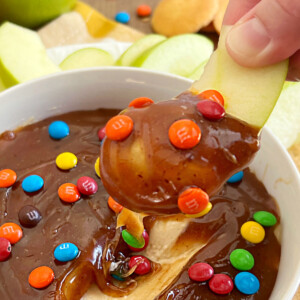 caramel apple dip on sliced apple with mini m and m's