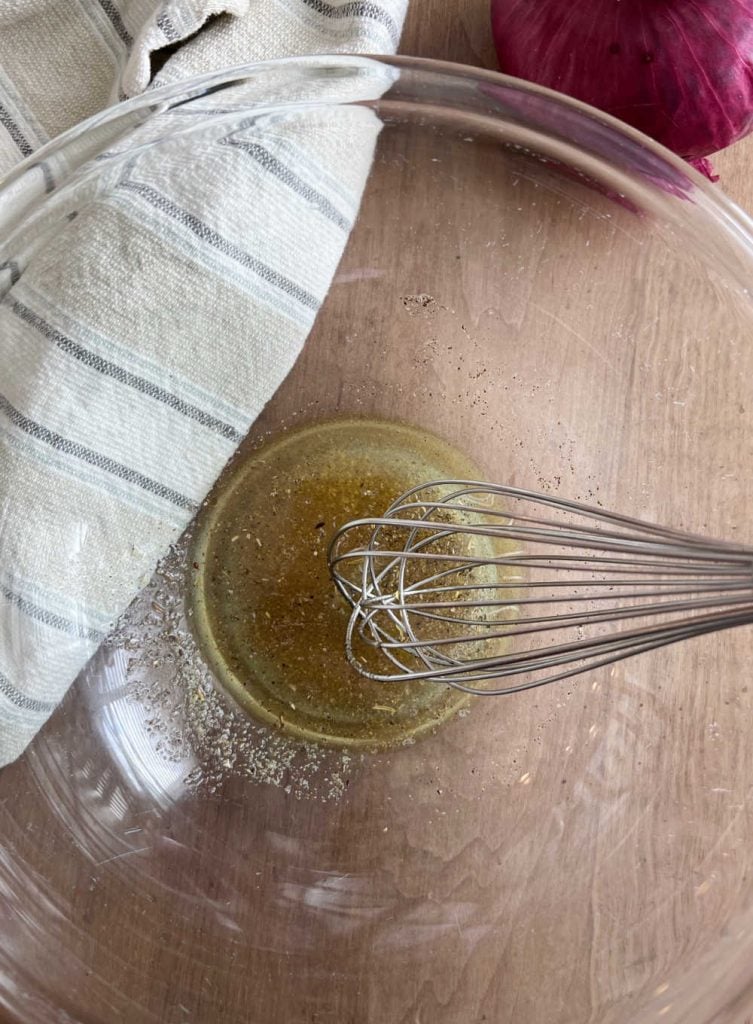 whisk lemon dressing for chickpea salad in mixing bowl