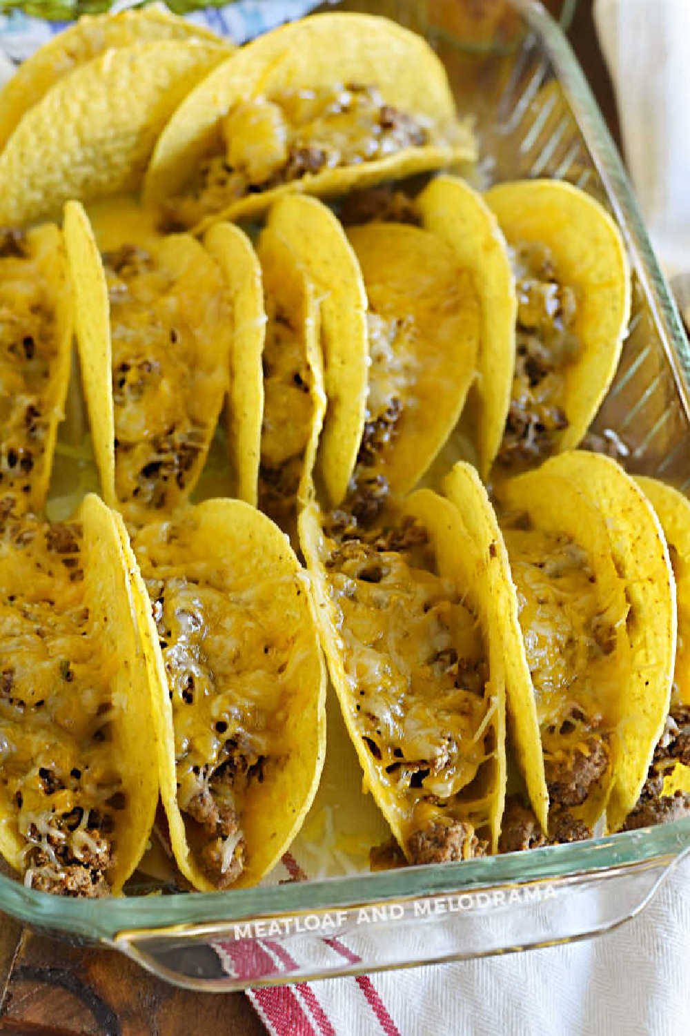 ground beef and melted cheese in baked taco shells