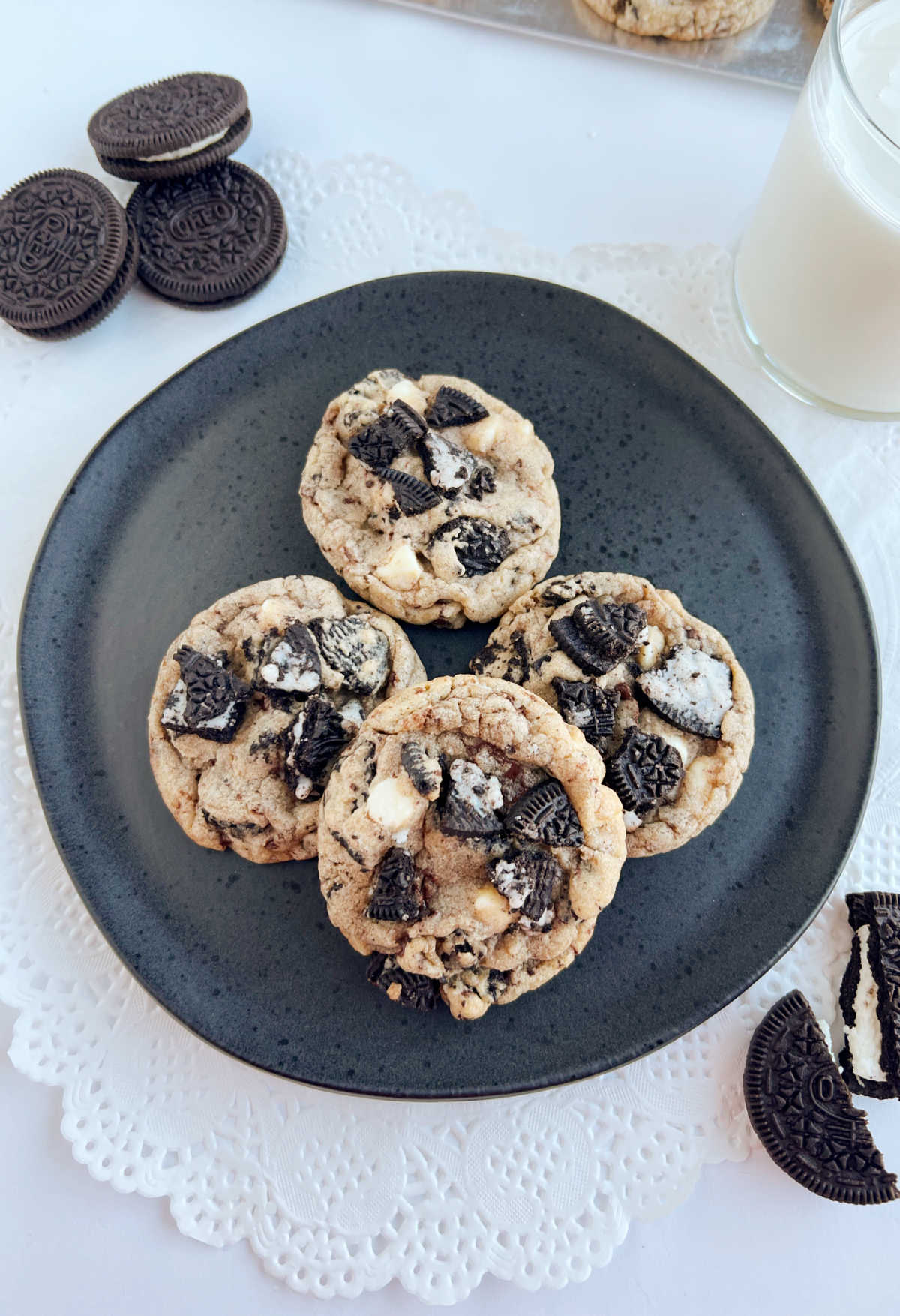 oreo chocolate chip cookies with oreo cookie pieces and glass of milk