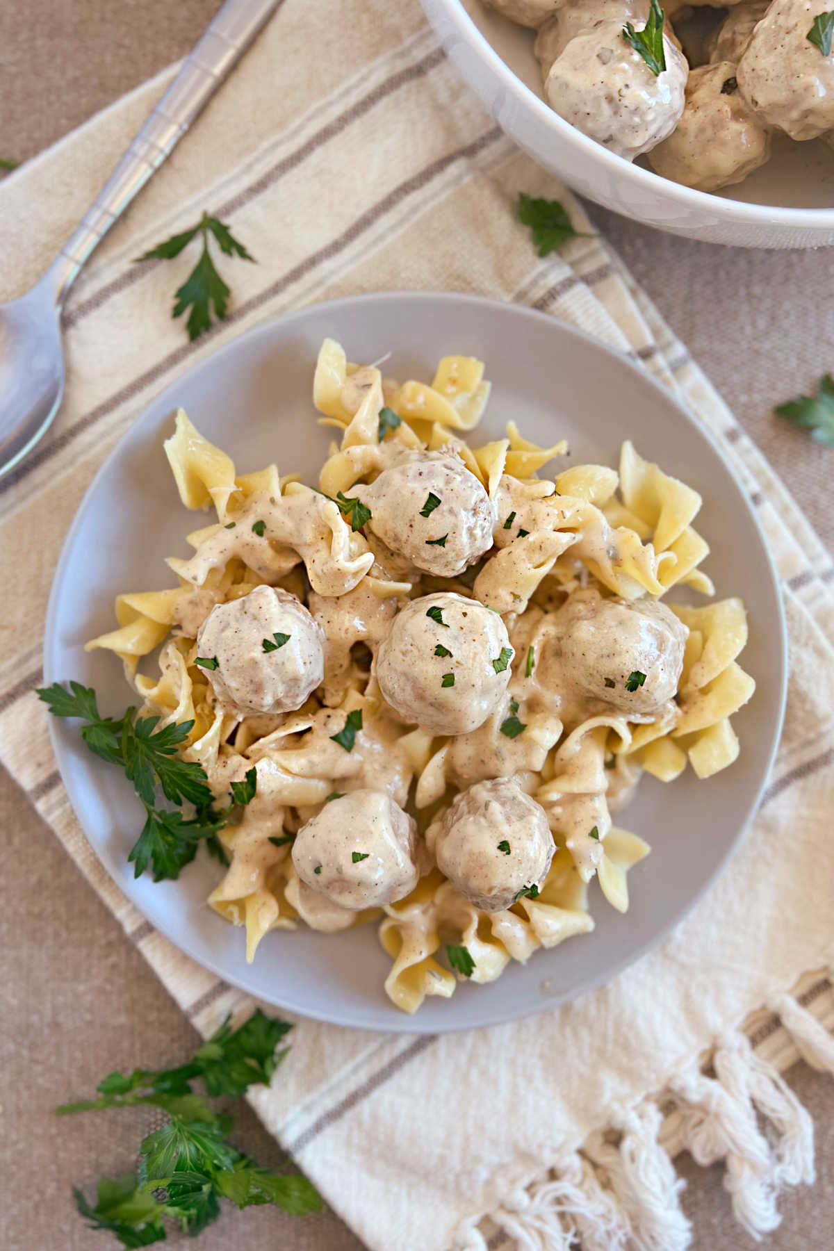 plate of Swedish meatballs in creamy white sauce over egg noodles
