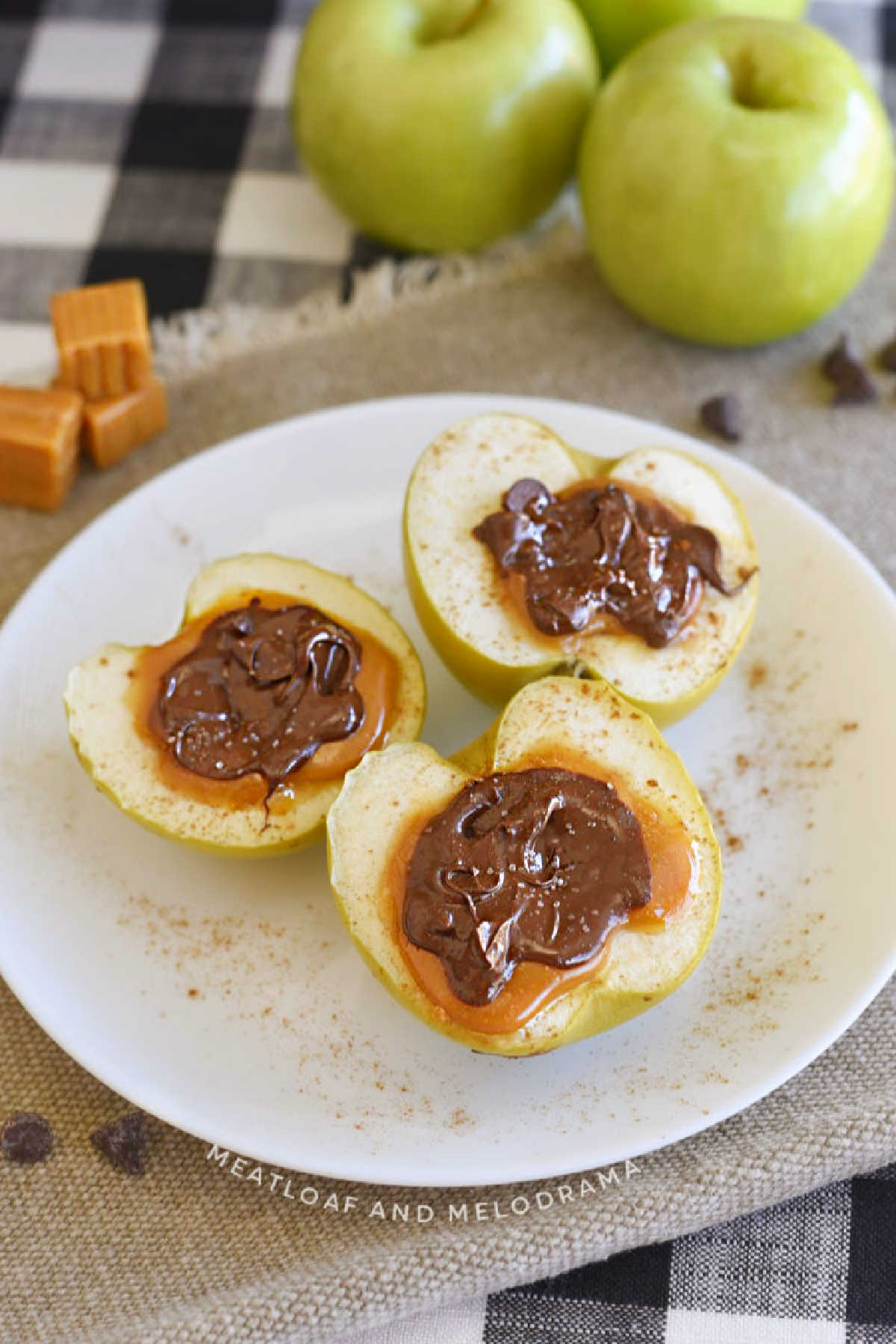 baked apples stuffed with caramel and melted chocolate on plate