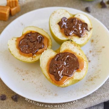 baked caramel stuffed apples with melted chocolate on a plate