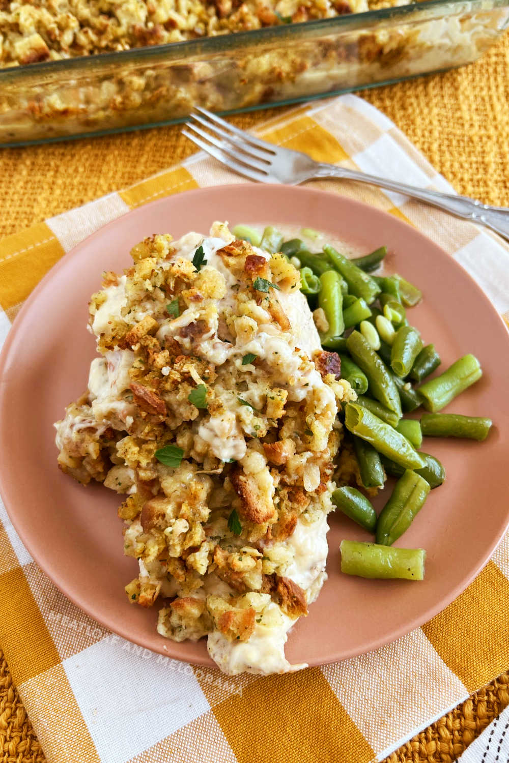 baked chicken breasts with stove top stuffing and green beans on plate