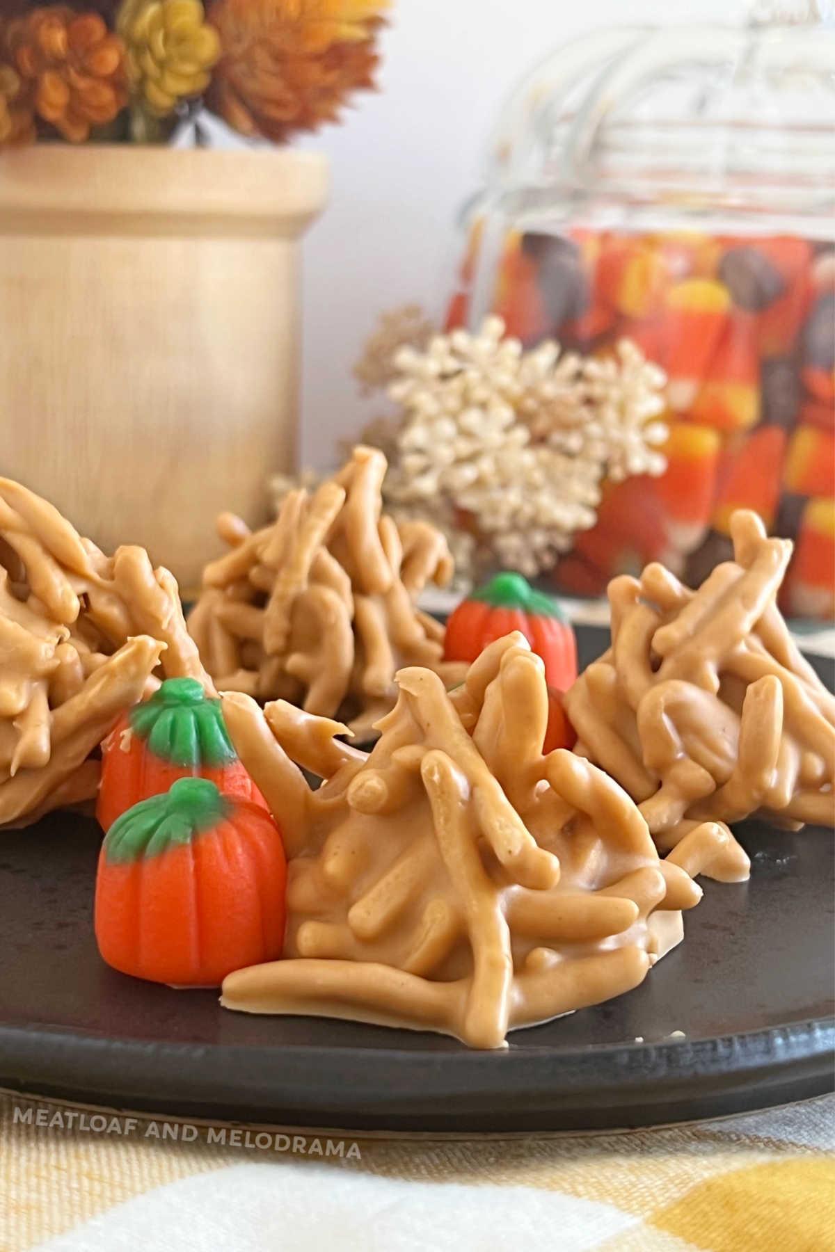 no bake haystack cookies with butterscotch morsels and marshmallow pumpkins on plate
