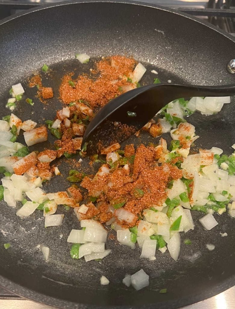 saute onion, jalapeno pepper and spices in skillet