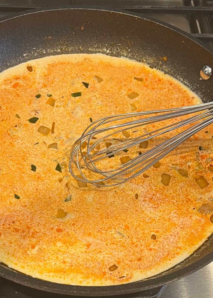 whisk heavy cream and spices in skillet