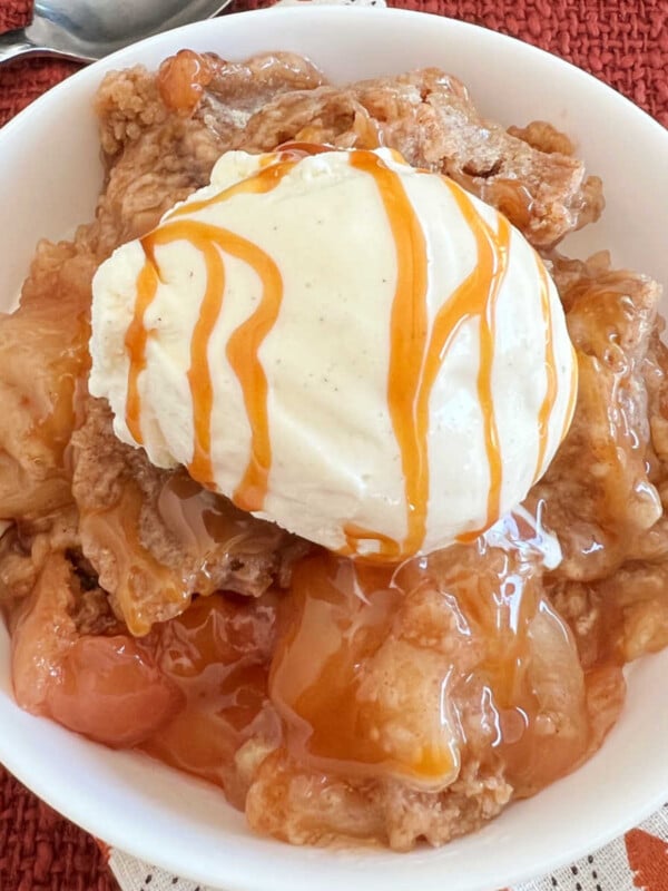 slow cooker apple cobbler with cake mix topping and vanilla ice cream