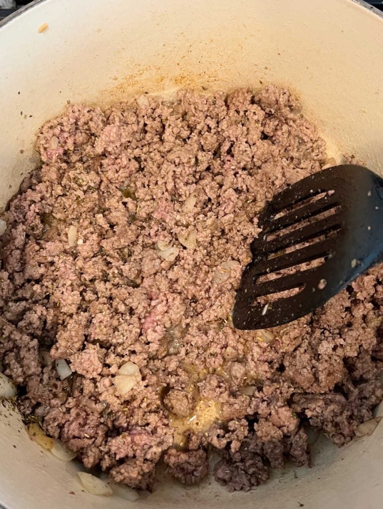 brown ground beef and onions in dutch oven
