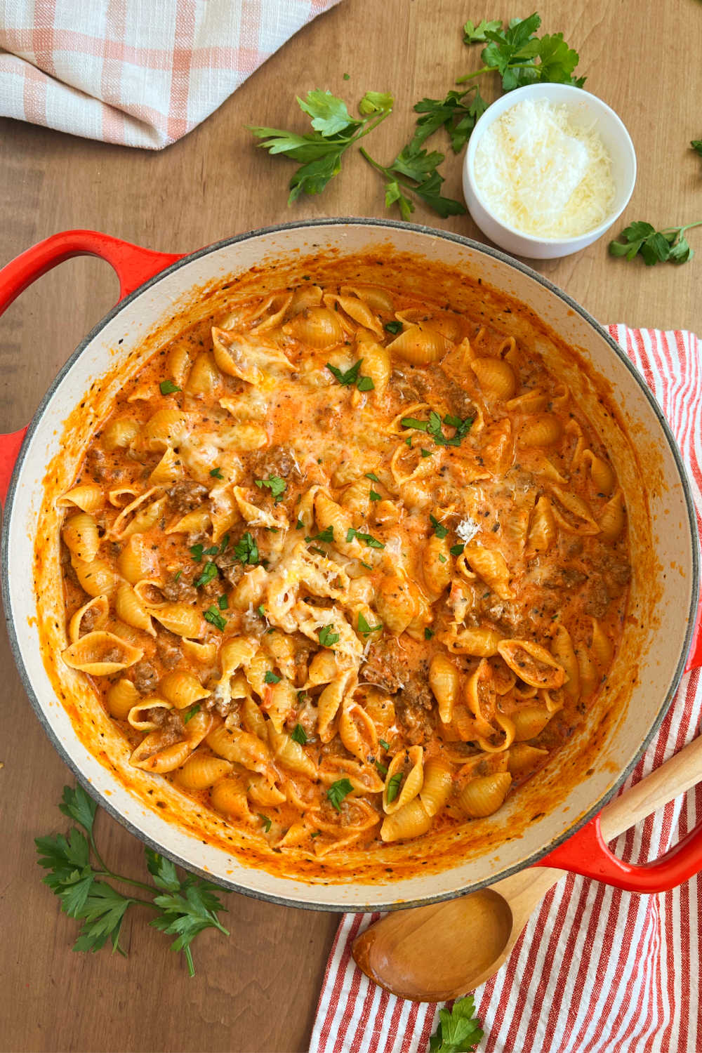 ground beef pasta recipe with pasta shells in creamy tomato sauce in dutch oven