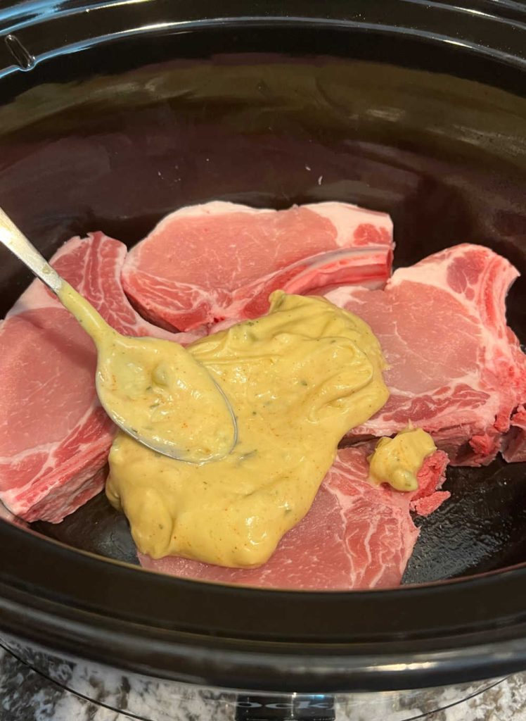 spread soup mixture over bone-in pork chops in slow cooker