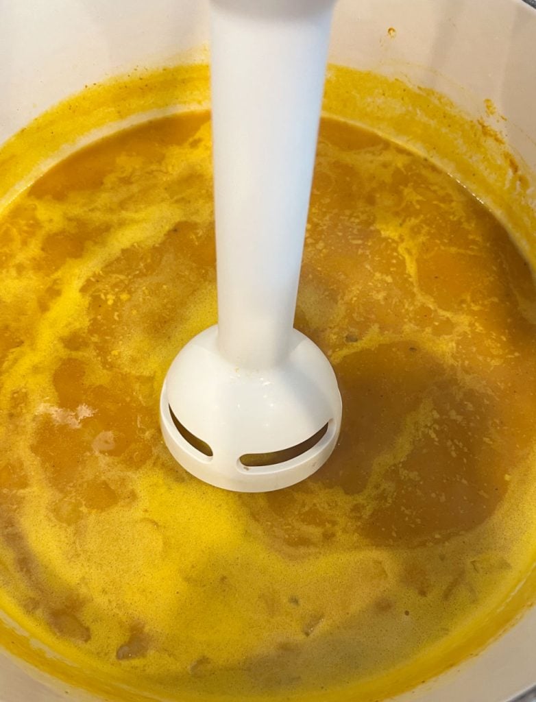 immersion blender in pot of pumpkin soup