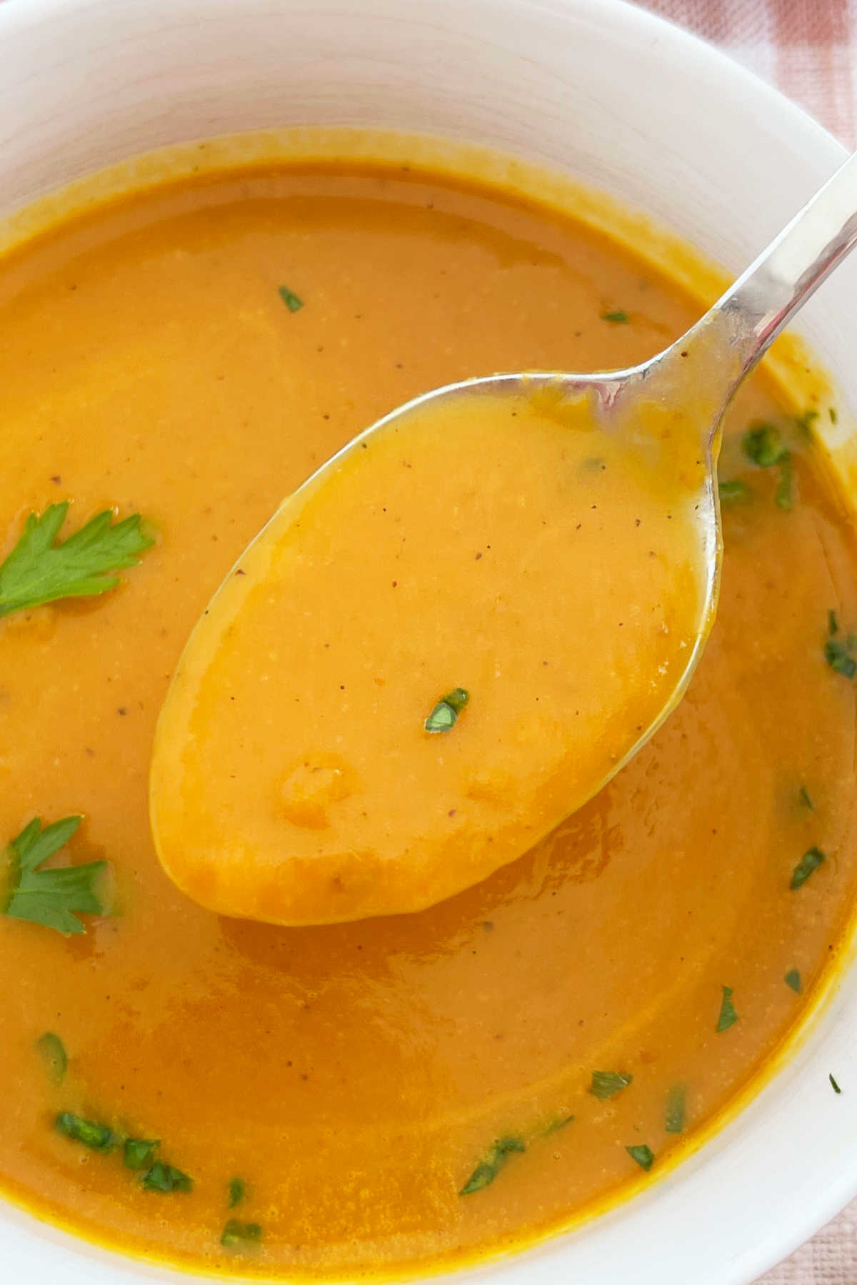 pumpkin soup made with canned pumpkin on a spoon over a bowl