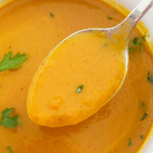 pumpkin soup made with canned pumpkin on a spoon with fresh parsley
