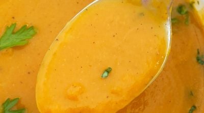 pumpkin soup made with canned pumpkin on a spoon with fresh parsley