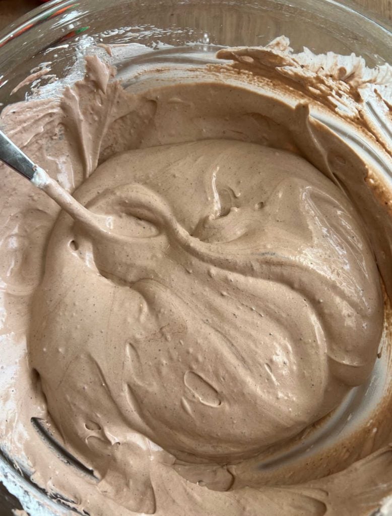 mix chocolate pudding and cool whip frosting in bowl