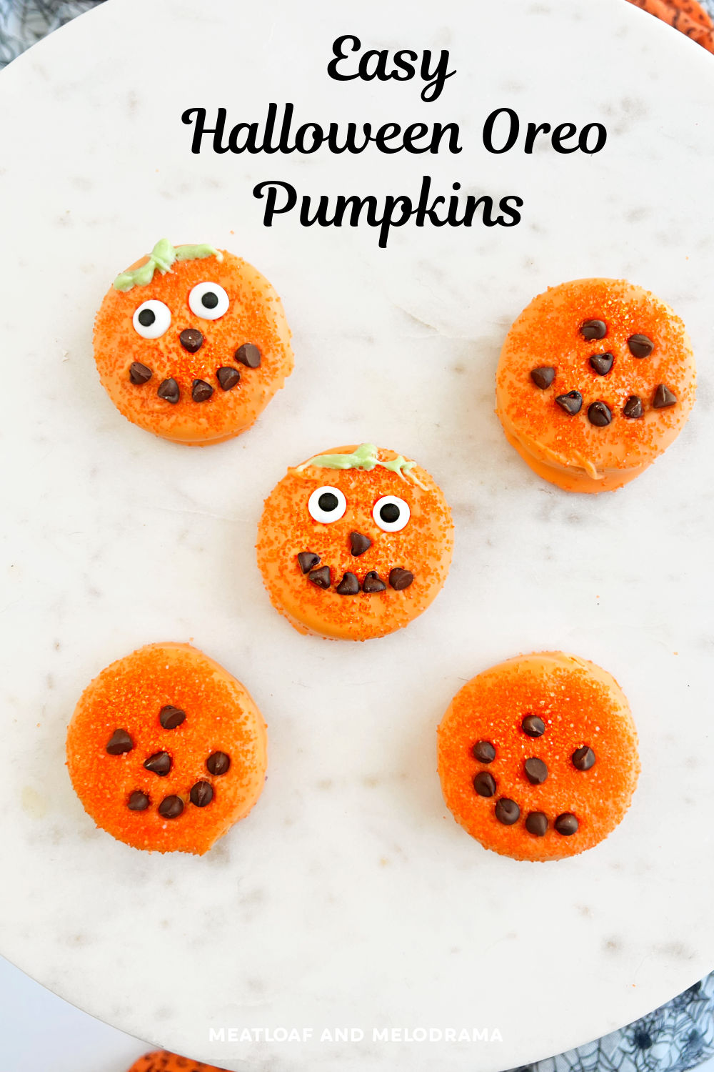 Halloween Oreo Pumpkin Treats are Halloween Oreo cookies in candy melts with candy eyes and chocolate chips. An easy Halloween party treat or fun dessert kids can make! via @meamel