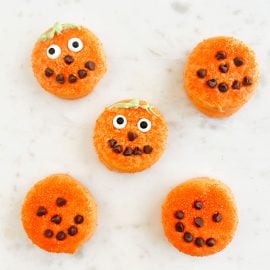 halloween oreo pumpkins in candy melts with candy eyes and mini chocolate chips