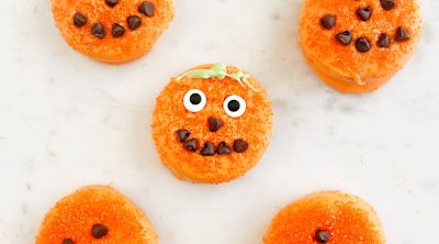 halloween oreo pumpkins in candy melts with candy eyes and mini chocolate chips