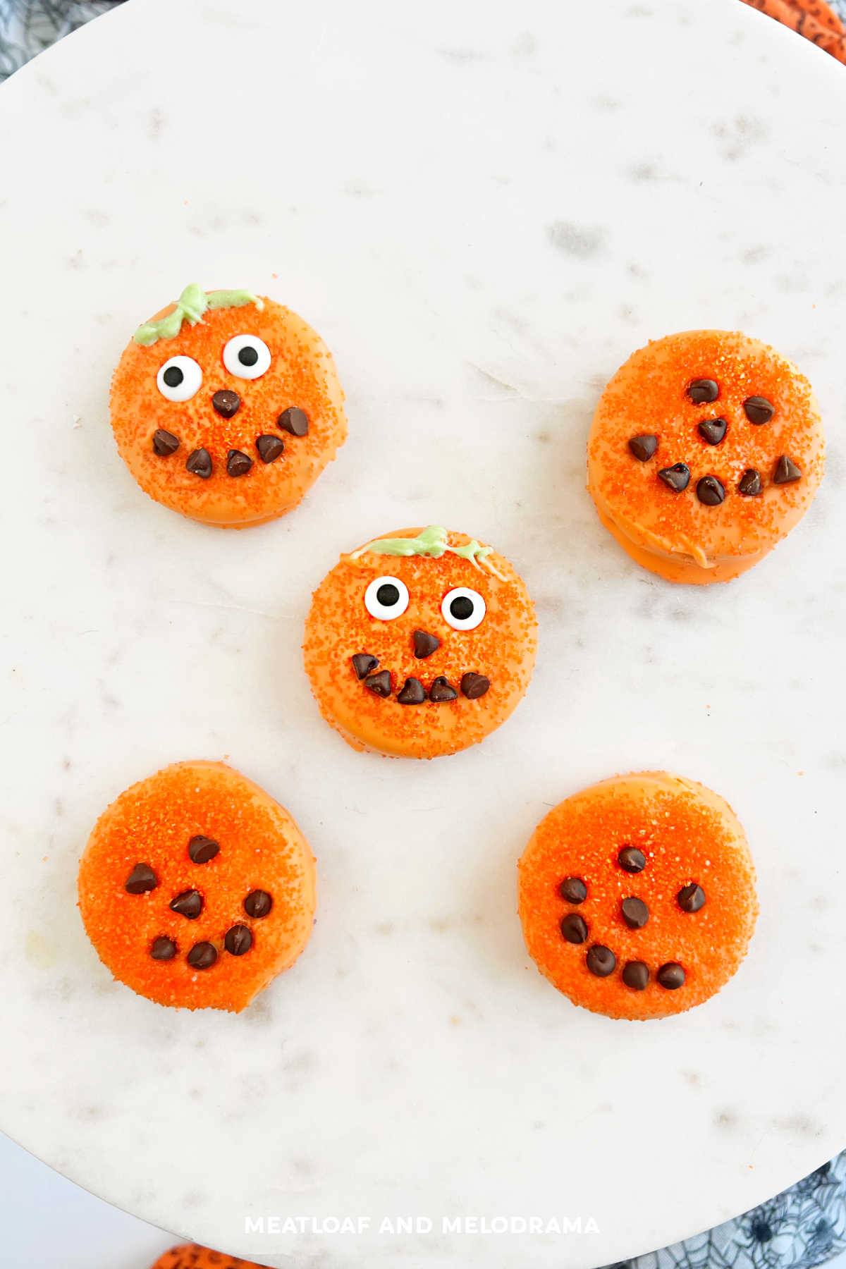 halloween oreo pumpkins with candy melts, candy eyes and mini chocolate chips