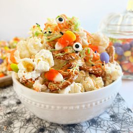 monster munch halloween popcorn with pretzels, candy eyes and candy on the table