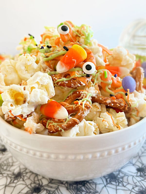 monster munch halloween popcorn with pretzels, candy eyes and candy on the table
