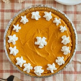 no bake pumpkin cheesecake pie with graham cracker crust and whipped cream