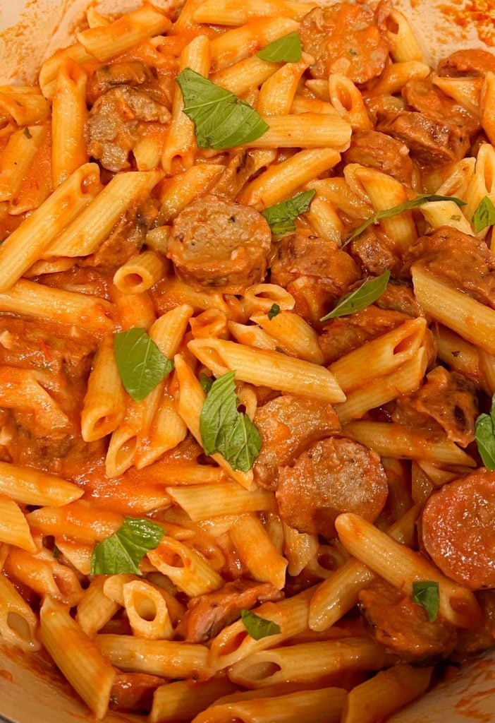 Italian sausage and penne pasta in vodka sauce with fresh basil