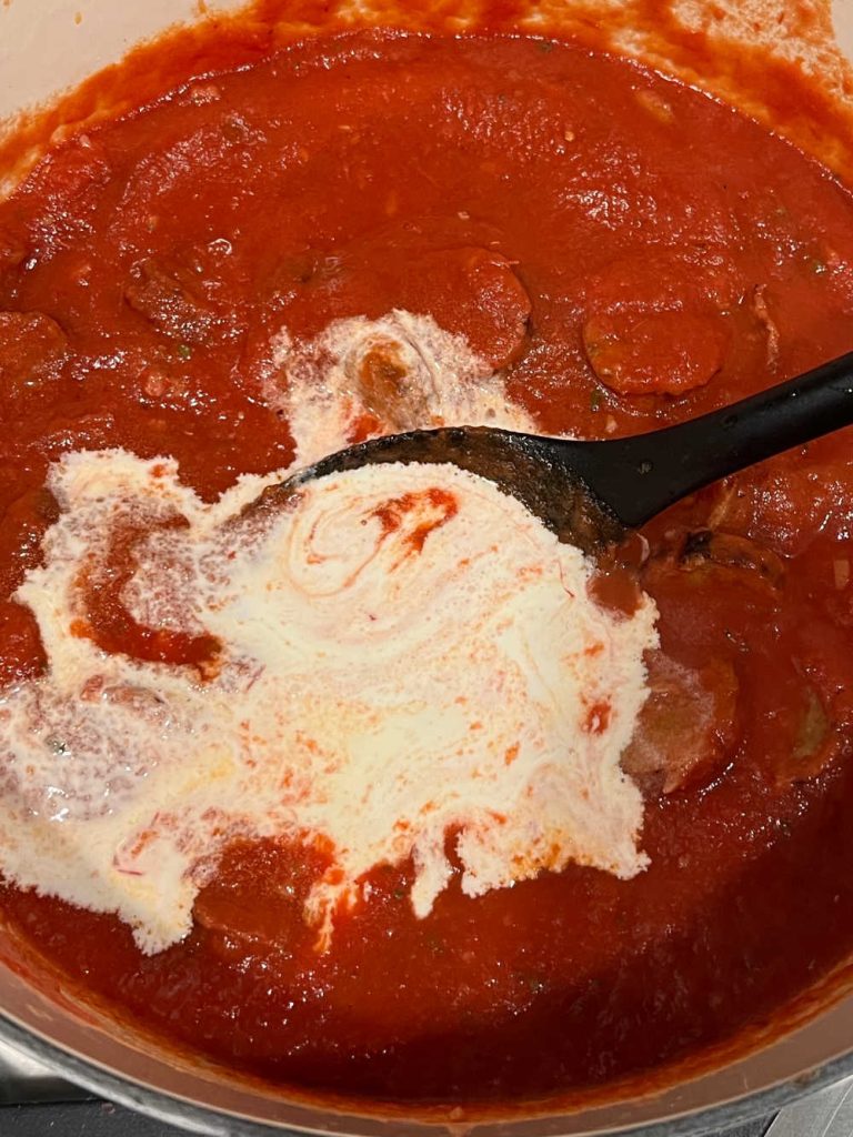 stir heavy cream in tomato sauce with vodka