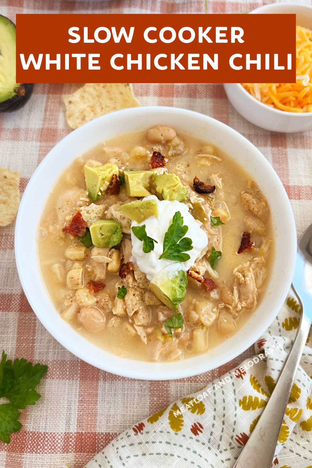 This creamy slow cooker white chicken chili recipe with white beans, corn and green chiles is an easy crockpot meal perfect for busy weeknights. One of the easiest slow cooker recipes you can make and absolutely delicious on a cold day! via @meamel