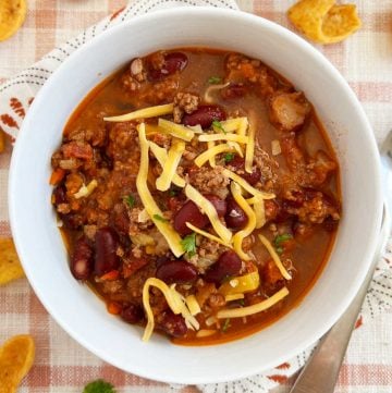 best chili recipe with ground beef and kidney beans cooked on stovetop in white bowl