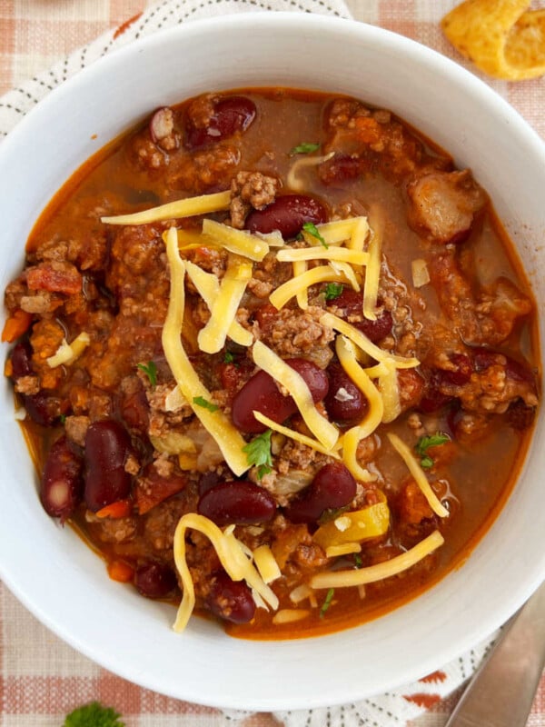 best chili recipe with ground beef and kidney beans cooked on stovetop in white bowl