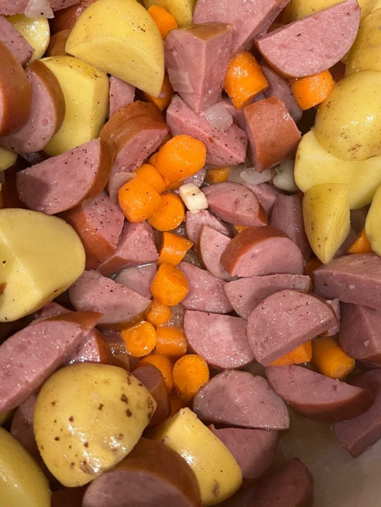 kielbasa smoked sausage with potatoes and carrots in dutch oven